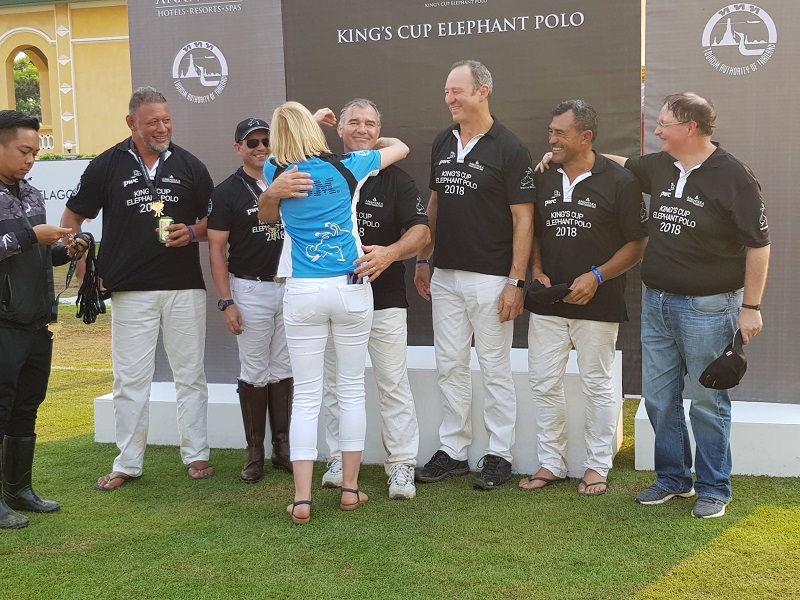 Former New Zealand All Blacks rugby players, who finished runners up, stand before a backdrop Sunday after the final.