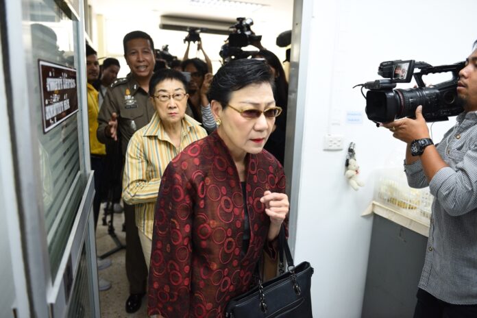 Ranee Saengyoktrakarn and Rattanachat Saengyoktrakarn meet with police Monday to hear charges related to their Feb. 19 assault on a pickup truck.