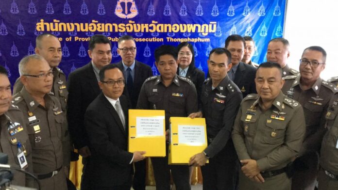 Deputy police commissioner Srivara Ransibrahmanakul, at right with crossed arms, poses with officials as he hands over the case file against Premchai Karnasuta on Tuesday in Kanchanaburi province.