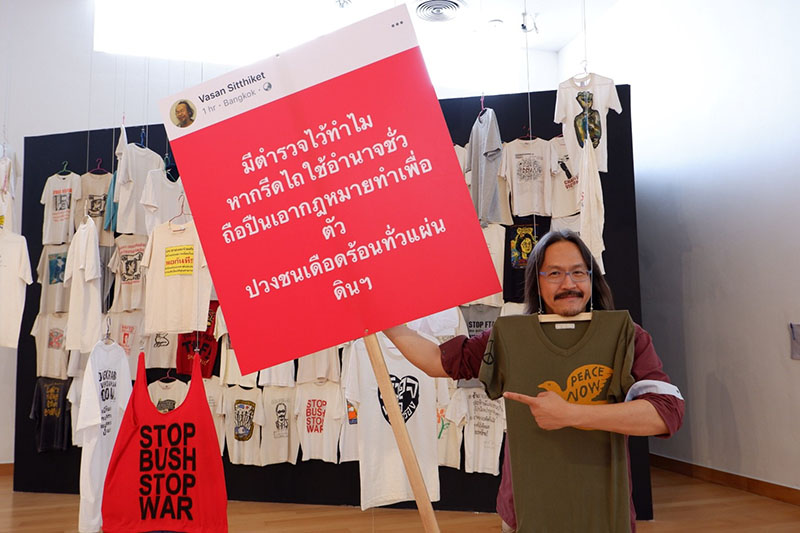 Pawit holds up some cutouts of Vasin’s politically charged Facebook statuses that visitors can hold up and take photos with.
