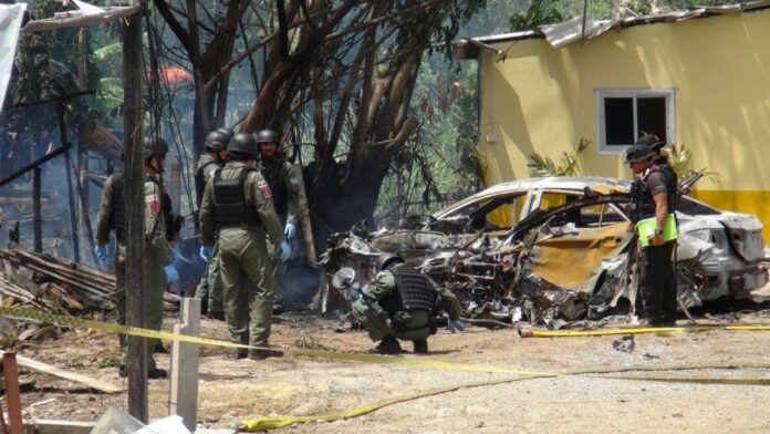 Security officers inspect the scene of a bomb attack in Pattani province on Feb. 27, 2016