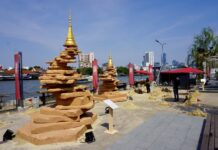 Course Correction: Which Way Will Bangkok’s Future Flow? A woman on Sunday poses for a picture with sand pagodas at Lhong 1919