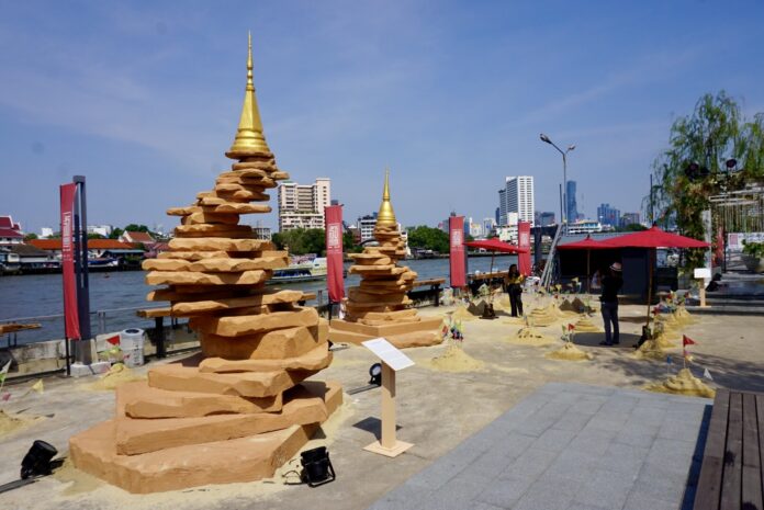 A woman on Sunday poses for a picture with sand pagodas at Lhong 1919 A woman on Sunday poses for a picture with sand pagodas at Lhong 1919
