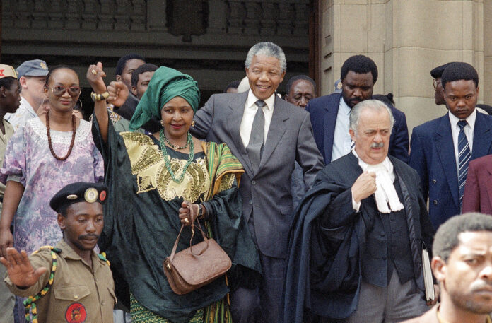 Winnie Mandela, centre left, wife of African National Congress leader Nelson Mandela, centre right, in 1991 leaves the Rand Supreme Court after an adjournment of her kidnap and assault court case. Photo: Associated Press