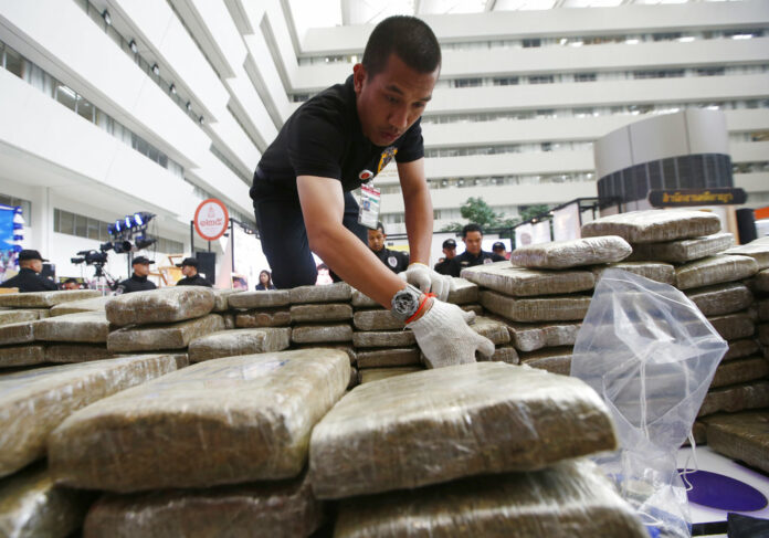 Police pack away seized marijuana after a press conference Tuesday in Bangkok. Photo: Sakchai Lalit / Associated Press