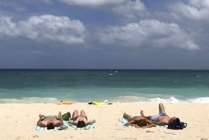 Tourists sunbathe at a beach on Boracay island in April in central Aklan province, Philippines. Photo: Aaron Favila / Associated Press
