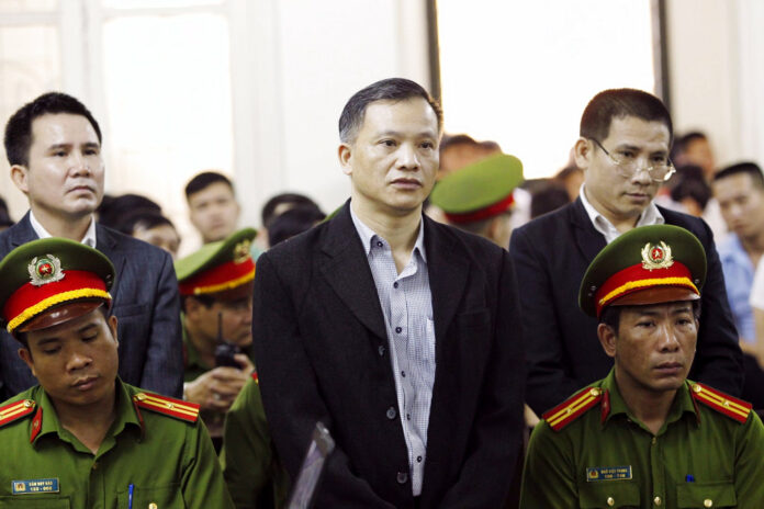 Prominent human rights lawyer Nguyen Van Dai, center, stands trial Thursday in Hanoi, Vietnam. Photo: Lam Khanh / Associated Press