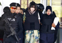 Vietnam Urges Malaysia Free 2nd Woman in N. Korean Killing Vietnamese Doan Thi Huong, center, is escorted by police as she leaves after a court hearing in 2018 at the Shah Alam High Court in Shah Alam, Malaysia. Photo: Sadiq Asyraf / Associated Press