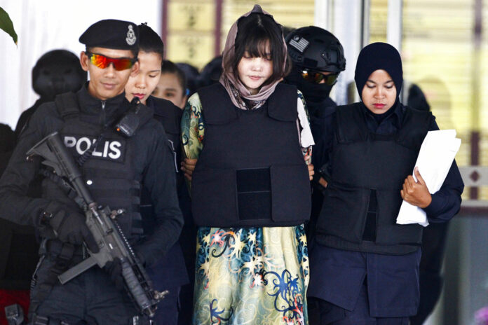 Vietnamese Doan Thi Huong, center, is escorted by police as she leaves after a court hearing in 2018 at the Shah Alam High Court in Shah Alam, Malaysia. Photo: Sadiq Asyraf / Associated Press