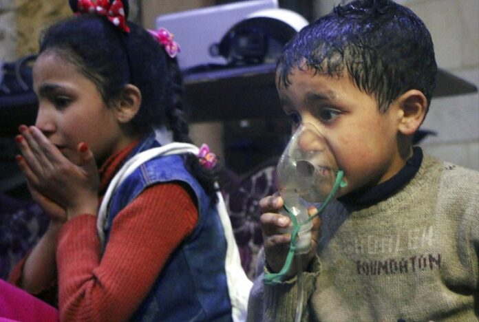 This image released by the Syrian Civil Defense White Helmets, shows a child receiving oxygen through respirators following an alleged poison gas attack in the rebel-held town of Douma, near Damascus, Syria. Photo: Syrian Civil Defense White Helmets / Associated Press