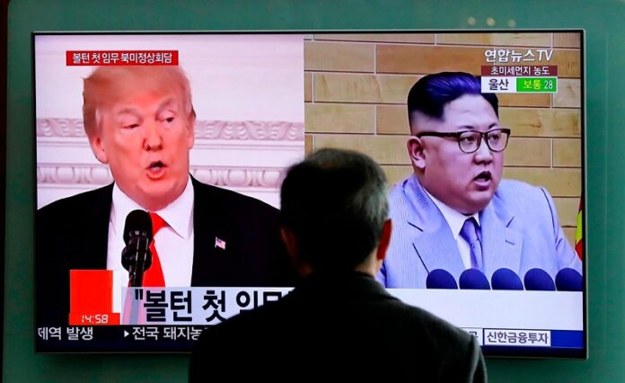 A man watches a TV screen showing file footages of U.S. President Donald Trump, left, and North Korean leader Kim Jong Un during a news program at the Seoul Railway Station in Seoul, South Korea. Photo: Lee Jin-man / Associated Press