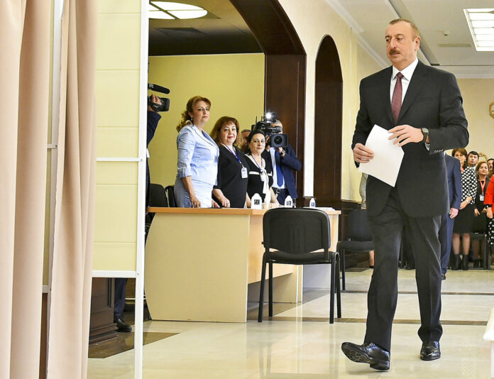 Azerbaijan President Ilham Aliyev walks to cast his ballot paper at a polling station during a presidential elections in Baku, Azerbaijan. Photo: Associeted Press