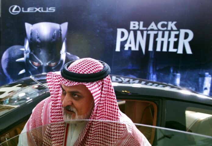 A visitor checks out a Lexus car, similar to a one used in the Black Panther film, that is on display at the King Abdullah Financial District Theater, in Riyadh, Saudi Arabia. Photo: Amr Nabil / Associated Press