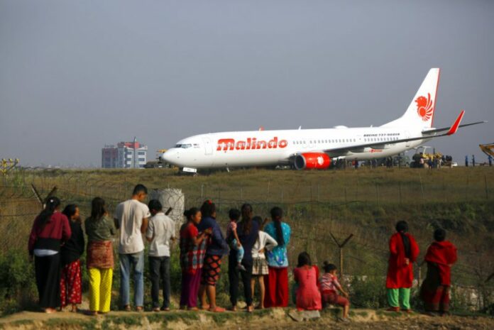 Nepal Airport Closed People watch a Malindo Air passenger plane after it skidded to the grassy area at the end of runway in Tribhuwan International Airport in Kathmandu, Nepal, Friday. Photo: Niranjan Shrestha / Associated Press