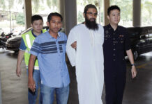Danish Citizen Jailed Under New Malaysian Anti-Fake News Law Danish national Salah Salem Saleh Sulaiman, second from right, escorted by police, arrives Monday at a court house in Kuala Lumpur, Malaysia. Photo: Associated Press