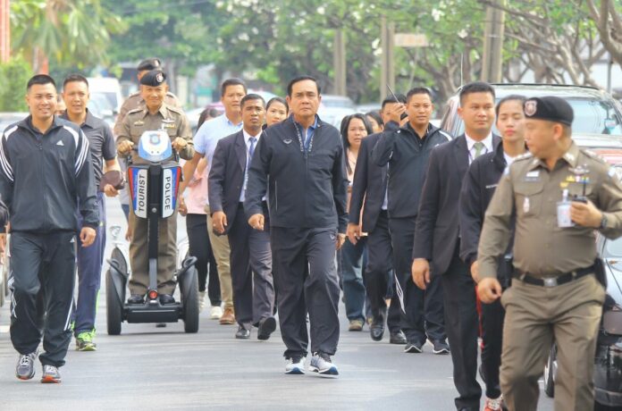 Junta chairman Prayuth Chan-ocha takes a walk around Government House on Wednesday