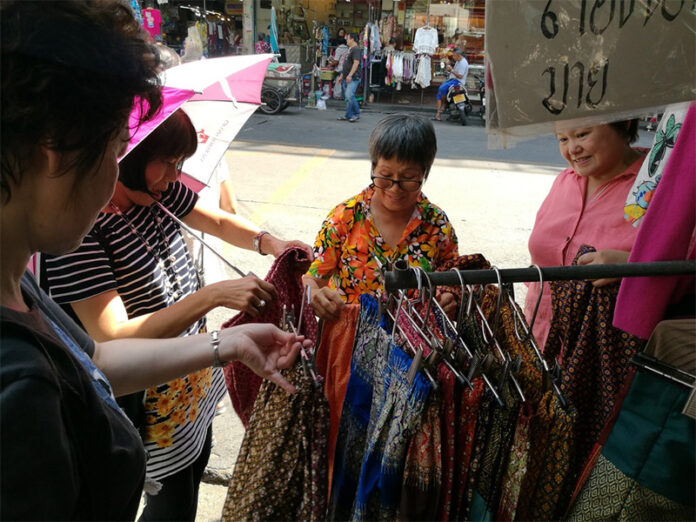 Banglamphu vendor Orasa Sae Jong sells traditional attire Thursday in Bangkok.