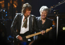 Bon Jovi Reunites to Enter Rock & Roll Hall of Fame Jon Bon Jovi, right, watches Richie Sambora play guitar during the Rock and Roll Hall of Fame Induction ceremony on Saturday. Photo: David Richard / Associated Press