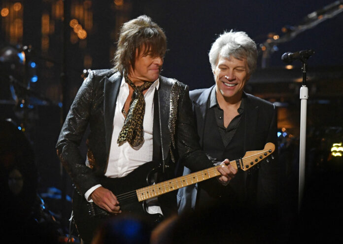 Jon Bon Jovi, right, watches Richie Sambora play guitar during the Rock and Roll Hall of Fame Induction ceremony on Saturday. Photo: David Richard / Associated Press