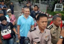 Lese Majeste Convict Somyot Freed Somyot Prueksakasemsuk, at center in blue shirt, leaves the Bangkok Remand Prison early Monday morning. Photo: Watthana Praisonta