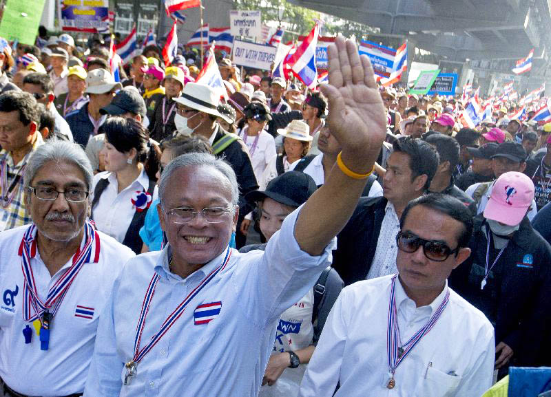 Suthep Thaugsuban waves to supporters on Jan. 17, 2014, while leading a street protest in Bangkok.