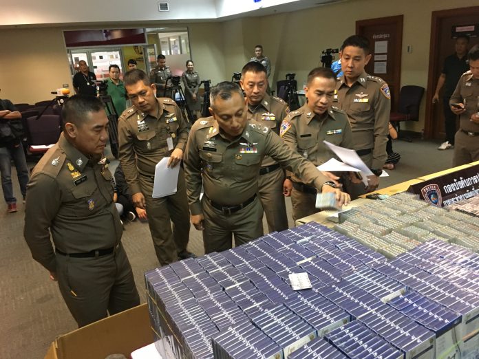 Police with boxes of seized Lyn diet pills Monday night.