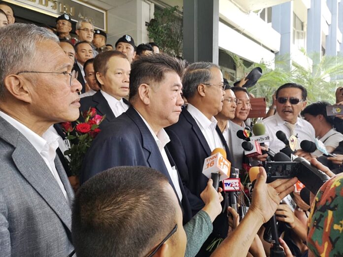 Pheu Thai politicians report to police Monday in Bangkok.