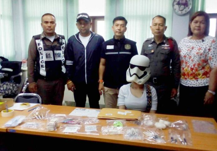 A woman suspected of opening an illegal orthodontic clinic wears a Stormtrooper mask Wednesday after she was arrested in Nakhon Si Thammarat.