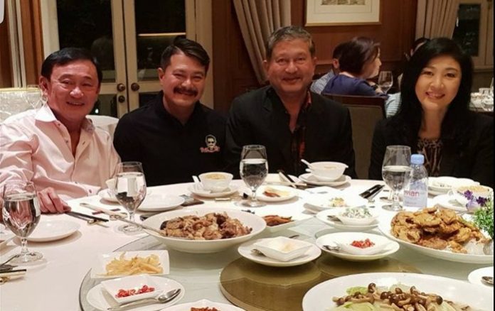 Thaksin Shinawatra and Yingluck Shinawatra pose for a photo with former minister Chalerm Yubamrung and his son Wan Ubumrung in Singapore on Saturday. Image: Wan Ubumrung