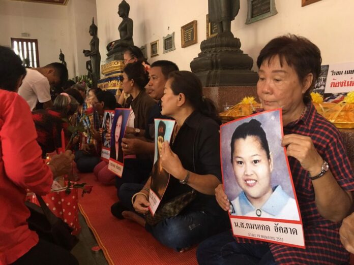 Portraits of 2010 crackdown victims are displayed Saturday during a religious ceremony at a temple in Bang Khen district.