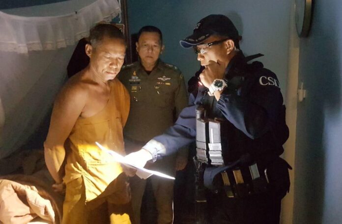 Police show Buddha Issara an arrest warrant at his temple Thursday morning. Image: Crime Suppression Division