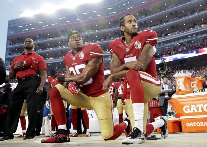 San Francisco 49ers safety Eric Reid (35) and quarterback Colin Kaepernick (7) kneel during the national anthem before an NFL football game against the Los Angeles Rams in 2016 in Santa Clara, California. Photo: Marcio Jose Sanchez / Associated Press