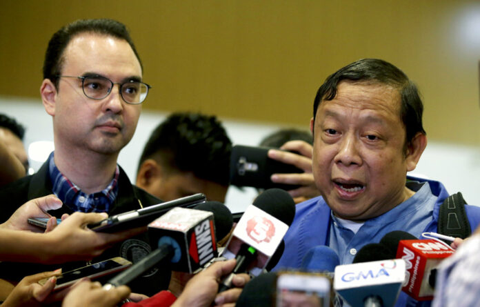 Philippine Ambassador to Kuwait Renato Villa, right, talks to reporters beside Philippine Foreign Secretary Alan Peter Cayetano at Manila's international airport. Photo: Aaron Favila / Associated Press