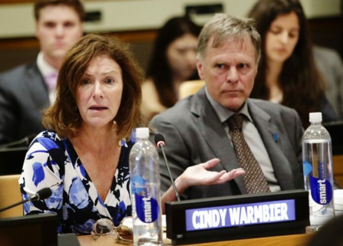 Fred Warmbier, right, listens as his wife Cindy Warmbier, speaks of their son Otto Warmbier. Photo: Frank Franklin II / Associated Press