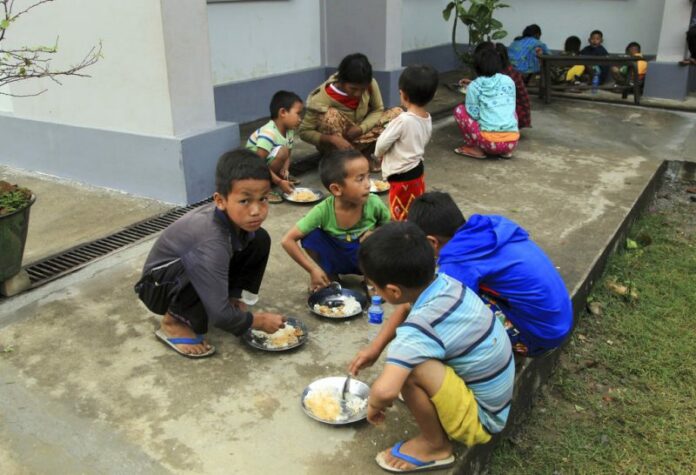Displaced ethnic Kachins have their meals in compound of Trinity Baptist Church refugee camp in Myitkyina, Kachin State, northern Myanmar. Photo: Min Kyi Thein / Associated Press