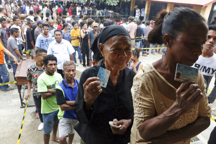 People queue up to give their votes at a polling station in May in Dili, East Timor. Photo: Kandhi Barnez / Associated Press