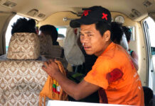 Myanmar Rebels Launch Attacks in North; at Least 15 Dead An injured man sits inside a vehicle Saturday in Muse, northern Shan state, Myanmar. Photo: Thaung Tu / Associated Press