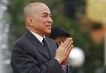 Cambodia Makes 1st Arrest on Charges of Insulting Monarchy Cambodia's King Norodom Sihamoni greets his government officers in November during the Independence Day celebrations, in Phnom Penh, Cambodia. Photo: Heng Sinith / Associated Press
