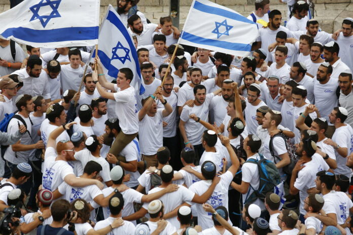 Israeli youths wave national flags in May outside the Old City's Damascus Gate, in Jerusalem. Photo: Ariel Schalit / Associated Press Israeli youths wave national flags in May outside the Old City's Damascus Gate, in Jerusalem. Photo: Ariel Schalit / Associated Press