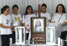 Indonesian Family That Bombed Churches Well Off, Friendly Family members pray during the wake for Marta Djumani, one of the victims of Sunday's church attacks, at a funeral home in Surabaya, East Java, Indonesia. Photo: Achmad Ibrahim / Associated Press