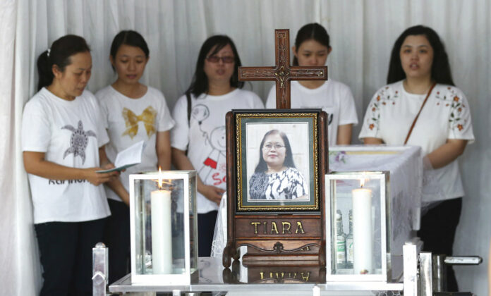 Family members pray during the wake for Marta Djumani, one of the victims of Sunday's church attacks, at a funeral home in Surabaya, East Java, Indonesia. Photo: Achmad Ibrahim / Associated Press