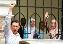 Malaysia’s Reformist Icon Anwar Freed, Given Royal Pardon Malaysian ousted Deputy Prime Minister Anwar Ibrahim raises his fist as he leaves the Federal High Court on Thursday in Kuala Lumpur. Photo: Andy Wong / Associated Press