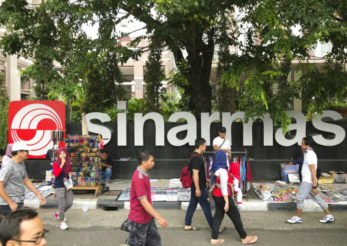 People walks past Sinarmas Land Plaza during a car-free day in 2017 at the main business district in Jakarta, Indonesia. Photo: Dita Alangkara / Associated Press