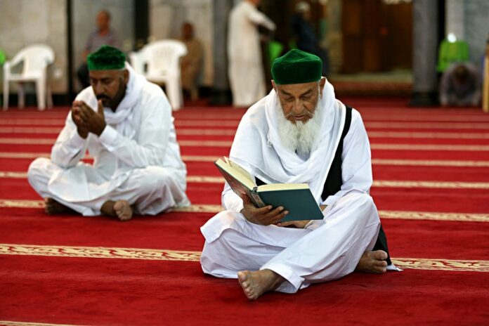 Muslim worshippers read the Quran, Islam's holy book, at Abdul-Qadir al-Gailani mosque, Wednesday in Baghdad, Iraq. Photo: Karim Kadim / Associated Press