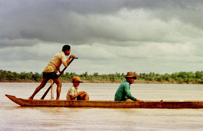 Villagers ride a dugout up the Mekong River in 1996 near Sambor, Cambodia where a major dam has been proposed. Photo: Richard Vogel / Associated Press Villagers ride a dugout up the Mekong River in 1996 near Sambor, Cambodia where a major dam has been proposed. Photo: Richard Vogel / Associated Press