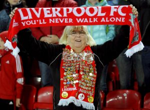 Liverpool fan holds up a scarf a Champions League soccer match between. Photo: Rui Vieira / Associated Press