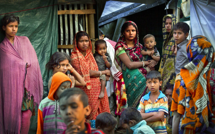 Hindu refugees stand outside their make shift shelters at Kutupalong refugee camp in January near Cox's bazar, Bangladesh. Photo: Manish Swarup / Associated Press