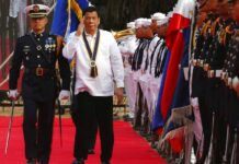 Duterte to Drug Suspects: ‘Want to Live Longer? Stay in Jail’ Philippine President Rodrigo Duterte stumbles while reviewing the troops during the 120th anniversary celebration of the Philippine Navy. Photo: Bullit Marquez / Associated Press