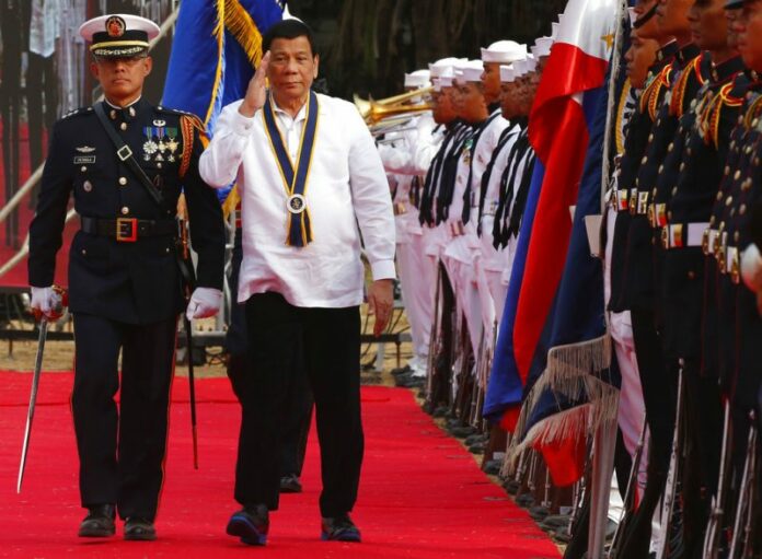 Philippine President Rodrigo Duterte stumbles while reviewing the troops during the 120th anniversary celebration of the Philippine Navy. Photo: Bullit Marquez / Associated Press