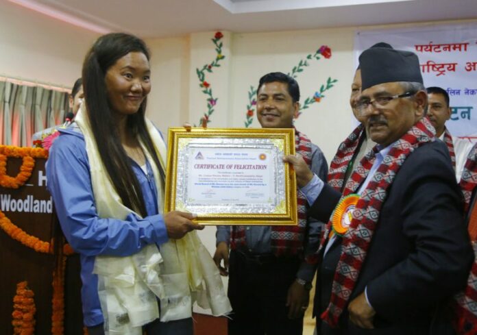 Nepalese woman climber Lhakpa Sherpa, left, is honored with an honorary certificate in Kathmandu, Nepal. Photo: Niranjan Shrestha / Associated Press